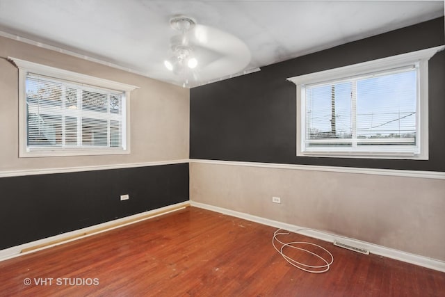 12416 S Trumbull Ave, Alsip, IL 60803 - spare room with baseboards, a ceiling fan, and wood finished floors