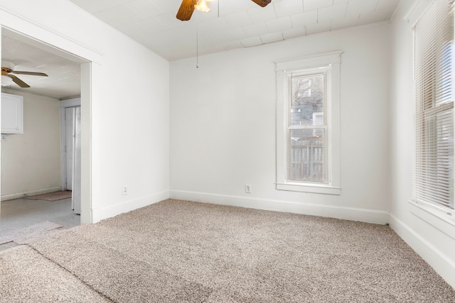 spare room featuring ceiling fan and carpet floors