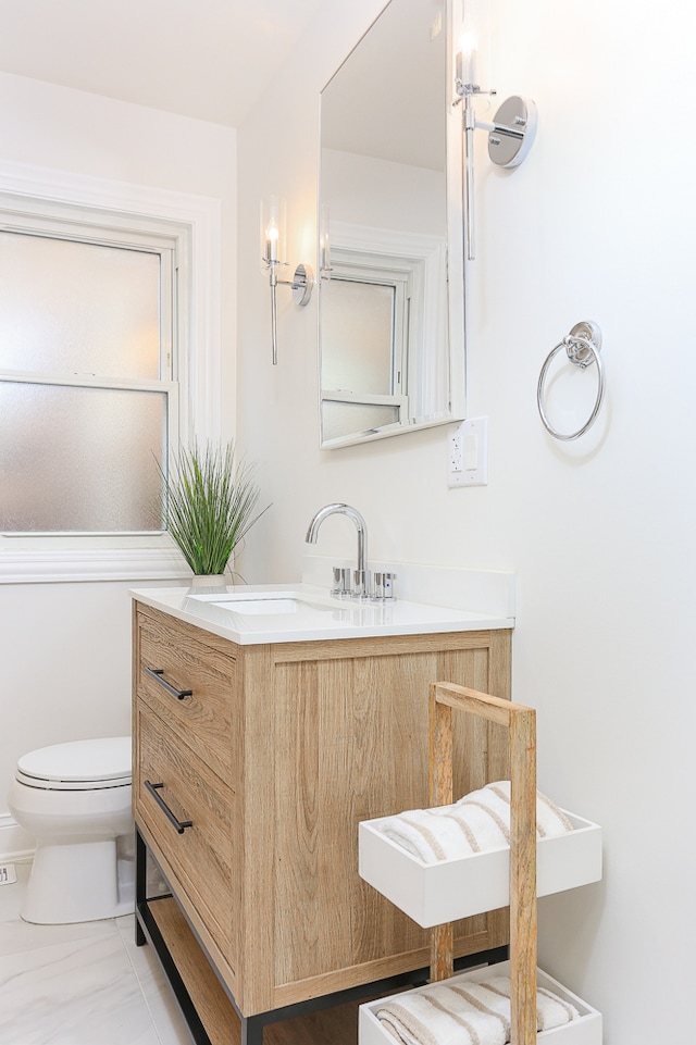 bathroom featuring tile patterned floors, vanity, and toilet