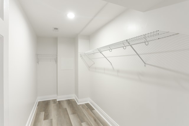 walk in closet featuring hardwood / wood-style floors