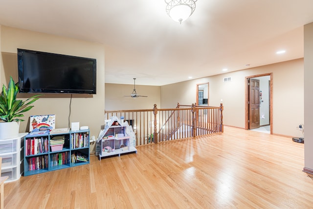 game room with ceiling fan and wood-type flooring