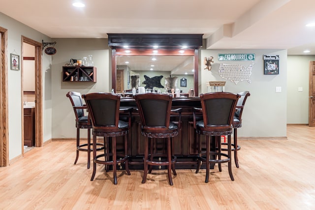 bar with light hardwood / wood-style floors