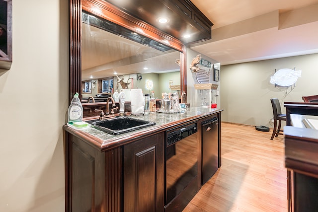 kitchen featuring sink, light wood-type flooring, dark brown cabinets, and black dishwasher