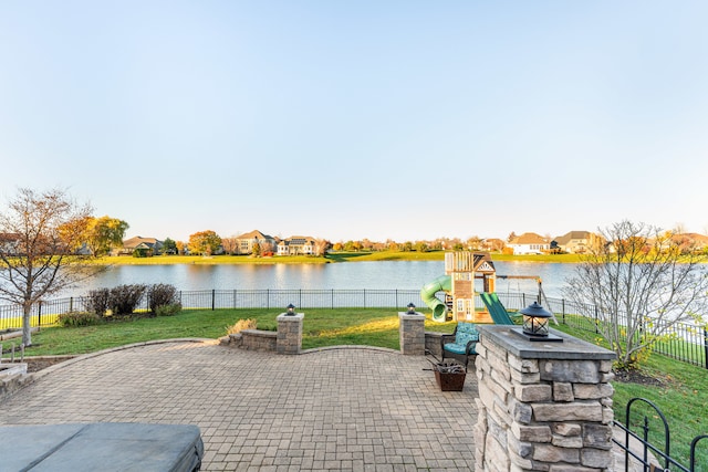 view of patio / terrace featuring a playground and a water view