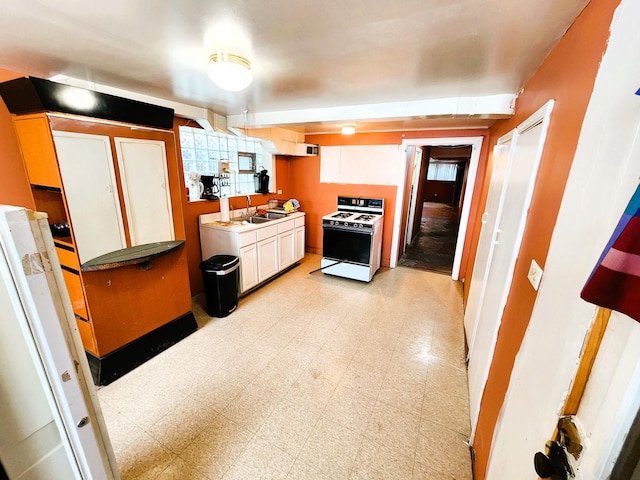 kitchen with white cabinets, white range oven, and sink