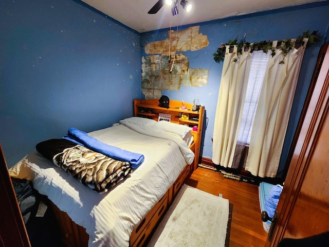 bedroom featuring hardwood / wood-style flooring and ceiling fan