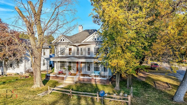 victorian house with covered porch and a front yard