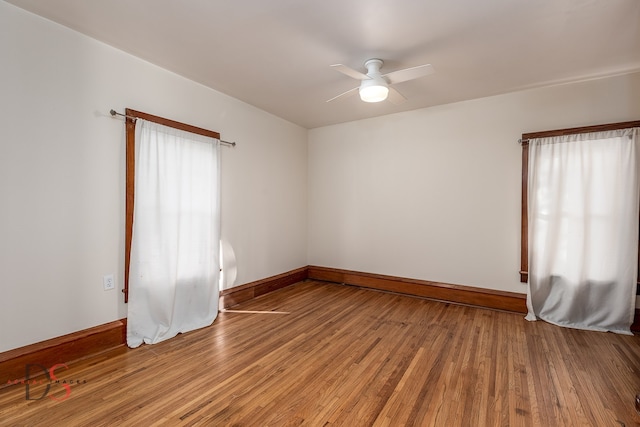 empty room with ceiling fan and hardwood / wood-style floors