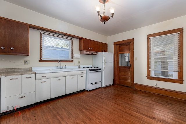 kitchen with white cabinetry, sink, dark hardwood / wood-style flooring, extractor fan, and white appliances