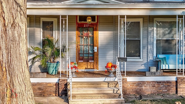 doorway to property featuring covered porch