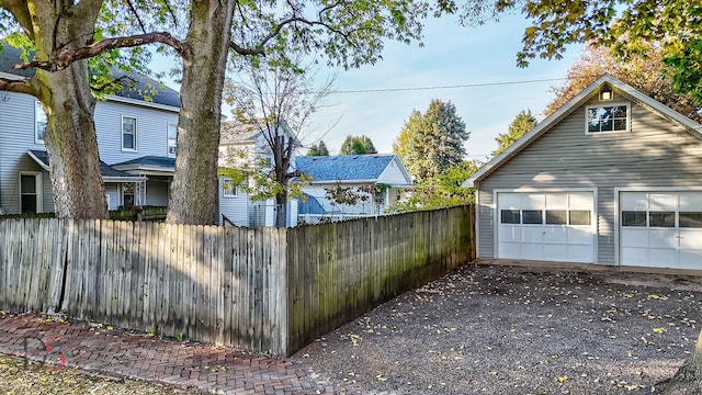 view of home's exterior featuring a garage and an outbuilding