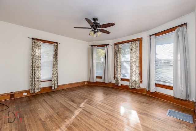 spare room with ceiling fan and wood-type flooring