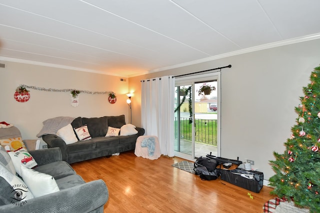 living room with wood-type flooring and ornamental molding