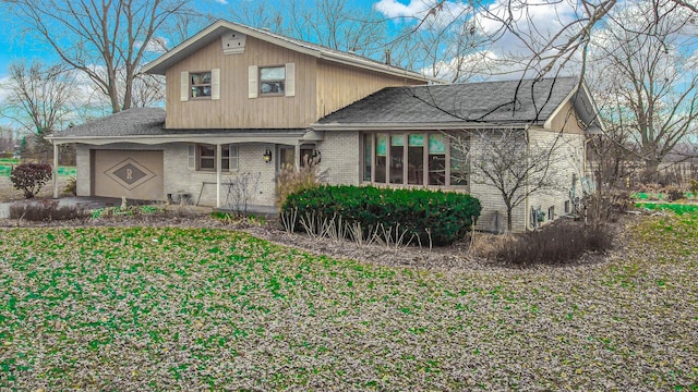 view of front of property featuring a garage and a front lawn