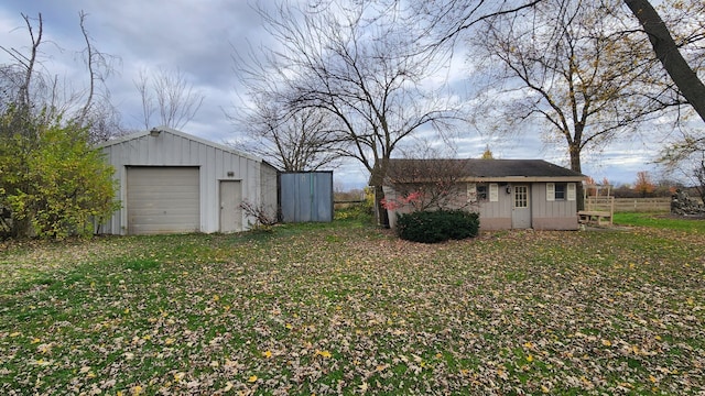 view of yard featuring an outbuilding and a garage