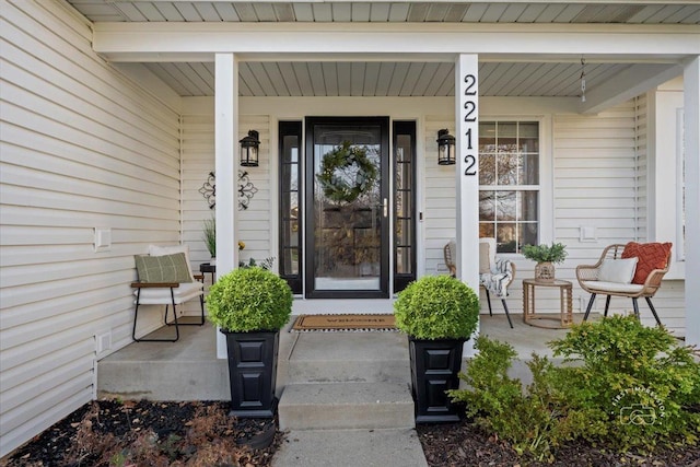 view of exterior entry with covered porch