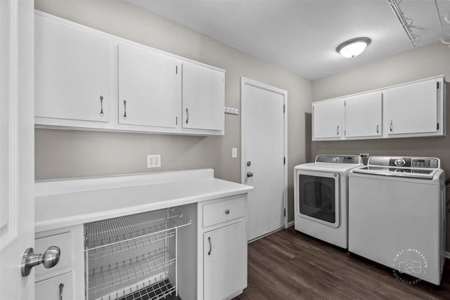 laundry area featuring washer and dryer, dark hardwood / wood-style floors, and cabinets