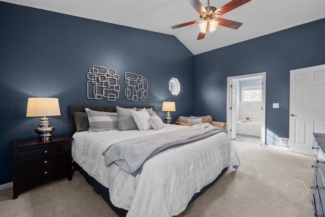 carpeted bedroom featuring vaulted ceiling, ceiling fan, and ensuite bath