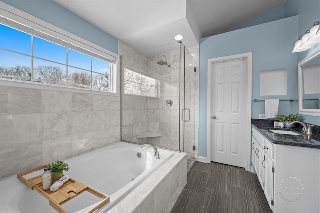 bathroom with vanity and independent shower and bath