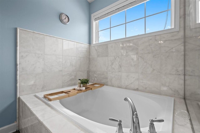 bathroom featuring a relaxing tiled tub