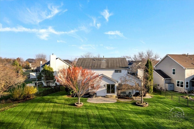 rear view of property featuring a yard and a patio