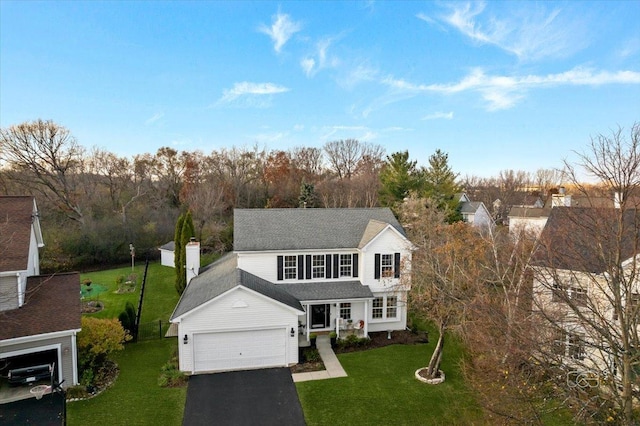 view of front property with a garage and a front yard