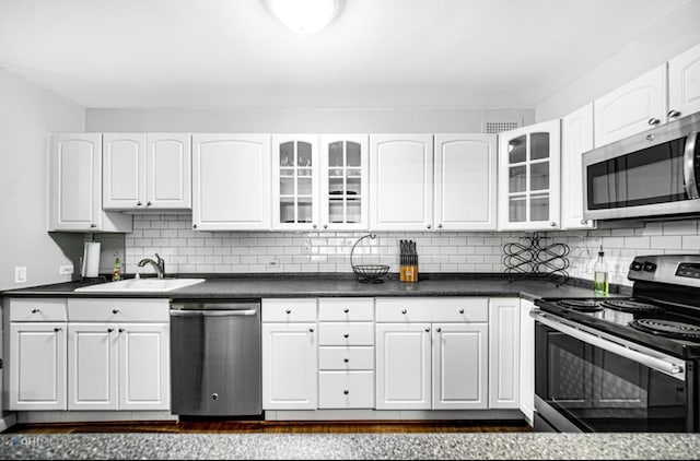 kitchen featuring sink, white cabinetry, stainless steel appliances, and tasteful backsplash