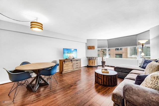 living room with dark hardwood / wood-style flooring