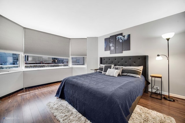 bedroom with dark hardwood / wood-style floors