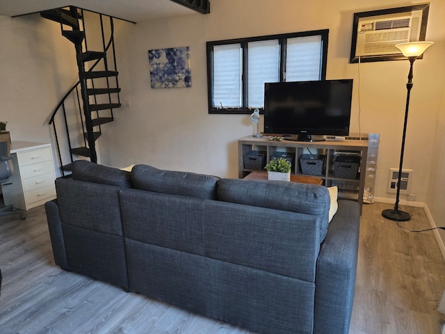 living room with hardwood / wood-style floors and a wall mounted AC