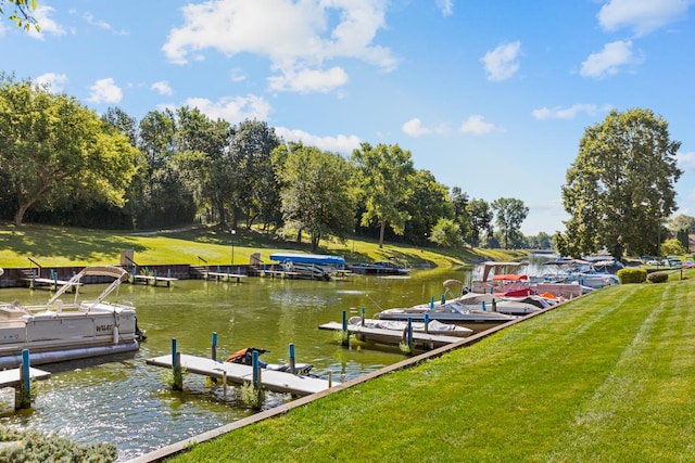 view of dock featuring a lawn and a water view