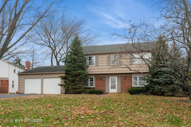 view of front of home with a front lawn and a garage