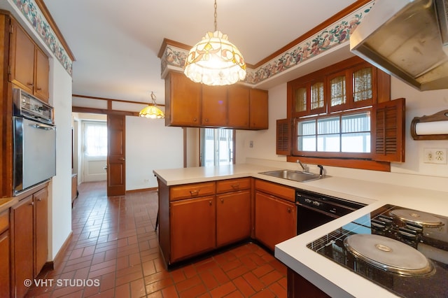 kitchen with sink, exhaust hood, kitchen peninsula, pendant lighting, and black appliances