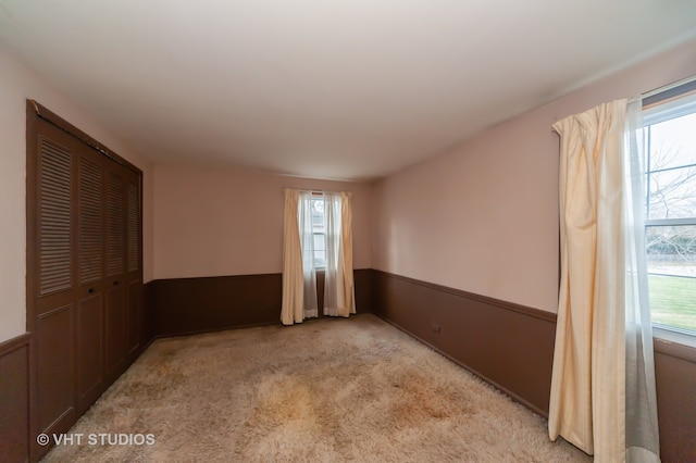 spare room with light carpet and a healthy amount of sunlight