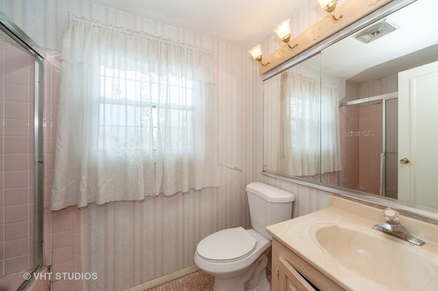 bathroom with tile patterned flooring, vanity, and toilet