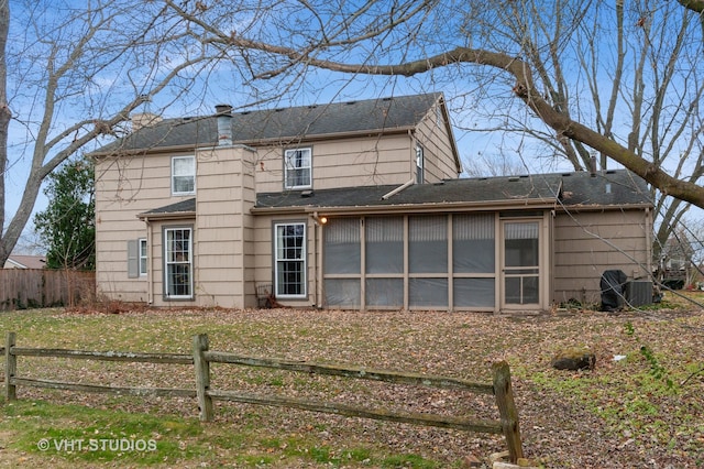 back of property featuring a yard, central AC unit, and a sunroom