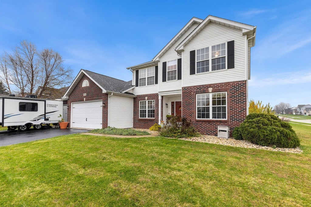 view of front of property with a front lawn and a garage