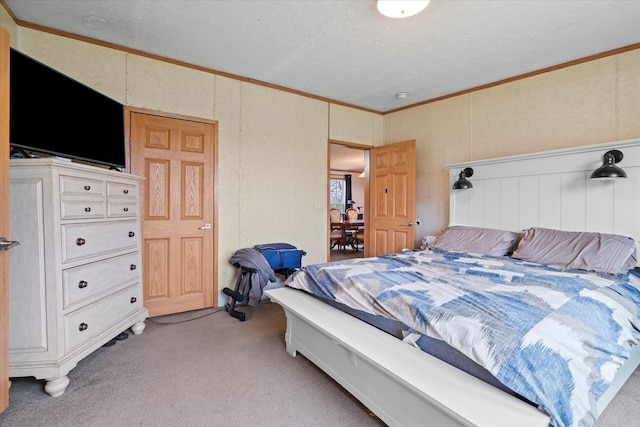 bedroom with a textured ceiling, crown molding, and light carpet