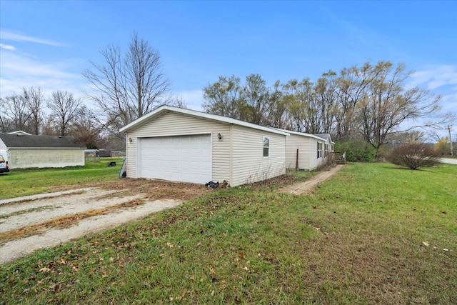 view of property exterior featuring a yard, an outbuilding, and a garage