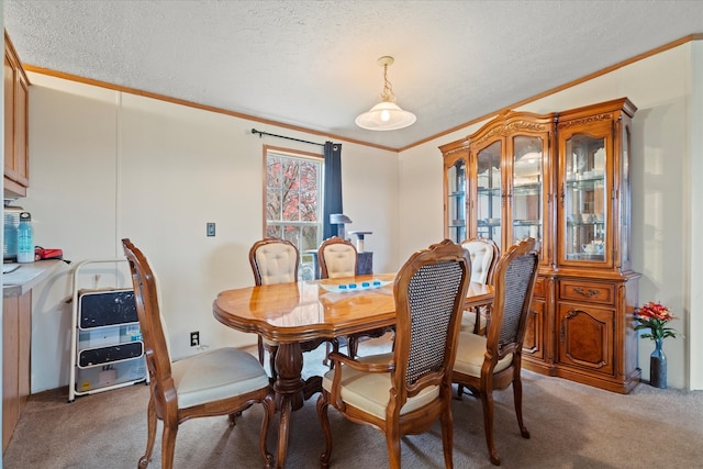 carpeted dining area with a textured ceiling and ornamental molding