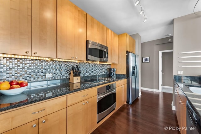 kitchen featuring black appliances, dark hardwood / wood-style floors, dark stone countertops, and backsplash