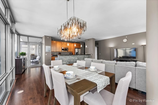 dining space with a notable chandelier and dark hardwood / wood-style floors