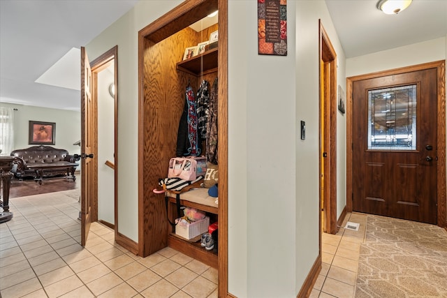 corridor featuring light tile patterned floors