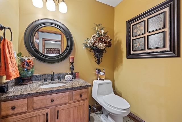 bathroom featuring tile patterned flooring, vanity, and toilet