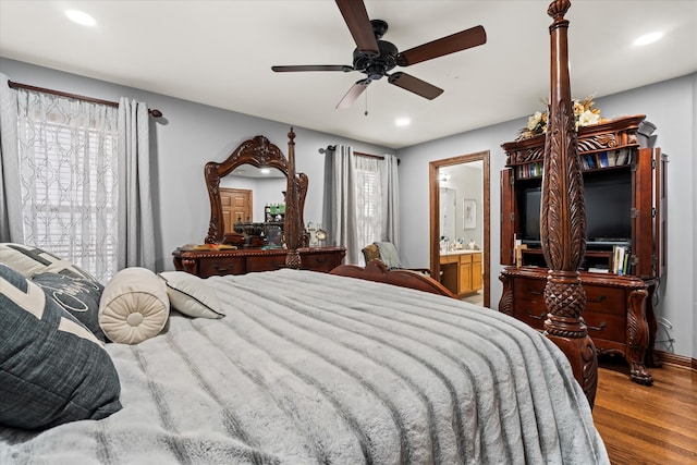 bedroom featuring ceiling fan, hardwood / wood-style floors, and ensuite bathroom