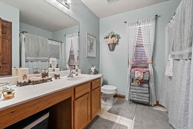 bathroom featuring tile patterned flooring, vanity, and toilet