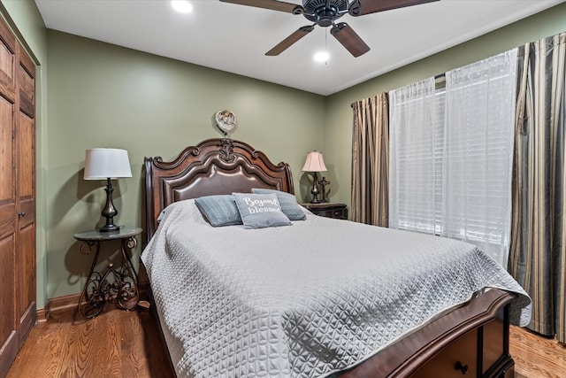 bedroom featuring hardwood / wood-style floors, a closet, and ceiling fan