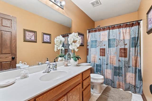 bathroom featuring tile patterned floors, curtained shower, vanity, and toilet