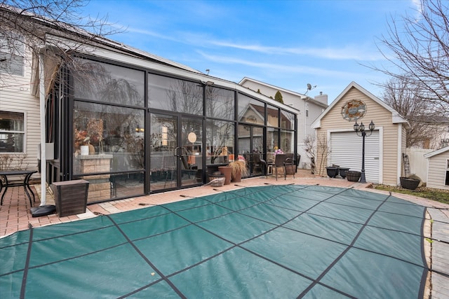 view of swimming pool with an outbuilding and a patio