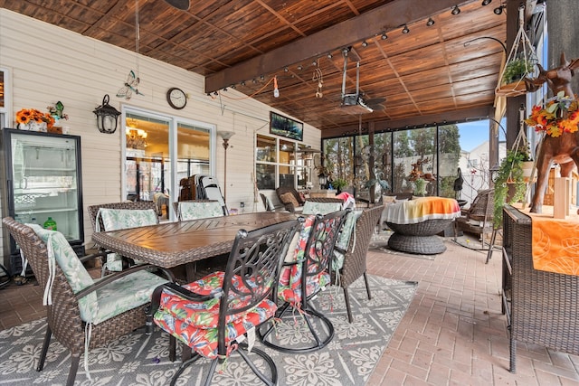 sunroom featuring a wealth of natural light, ceiling fan, and wood ceiling